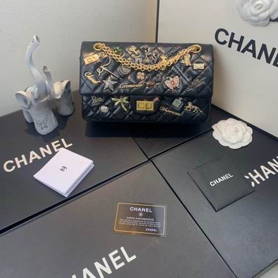 Chanel 2.55 Reissue Flap Bag in Black Quilted Leather with Charms